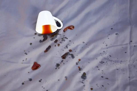 Spilled coffee on a gray bed. Stock Photos
