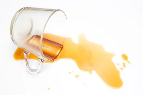 Spilled coffee or tea on the table surface. White background. Stock Photos