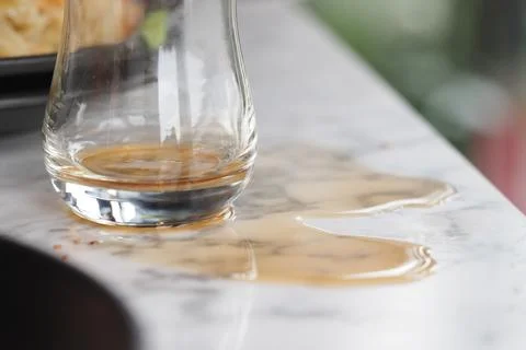 Spilled drink on a marble table in a dining setting Stock Photos