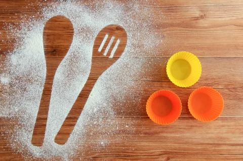 Spilled flour on the table. Spoon-shaped imprint in flour and cake molds. Woo Stock Photos