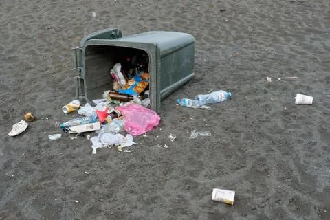 Spilled garbage on the beach. Empty used dirty plastic bottles Stock Photos