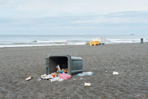 Spilled garbage on the beach. Empty used dirty plastic bottles Stock Photos
