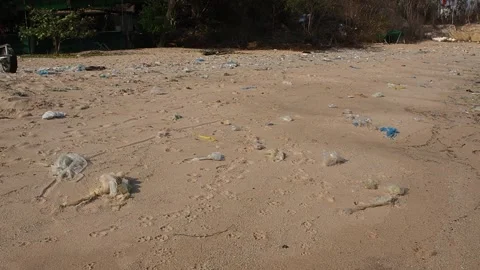 Spilled garbage on the beach near construction plant, Environmental pollutio Video stock 136867959
