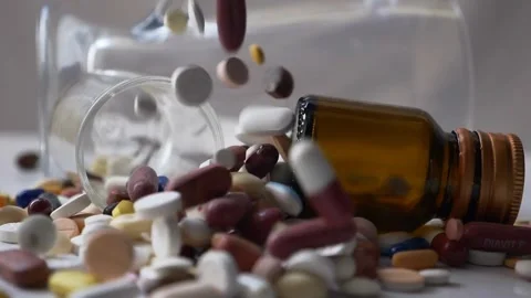 Spilled Medication Falling Pills on White Surface Stock Footage 304024713