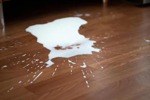 Spilled milk on the floor Stock Photos