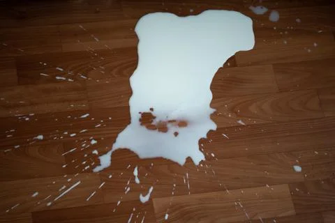 Spilled milk on the floor Stock Photos