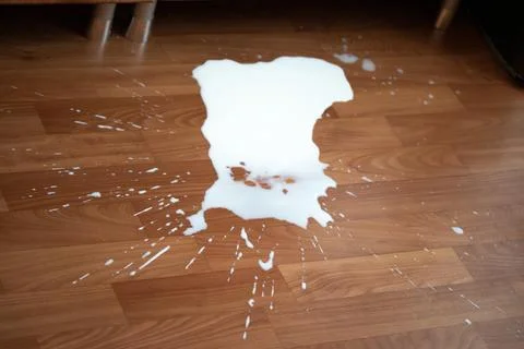 Spilled milk on the floor Stock Photos