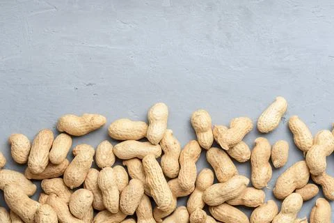 Spilled peanuts on a concrete surface with copies of space. Top view. 写真素材