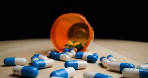 Spilled pill bottle inside out macro dolly shot Stock Footage 146759314