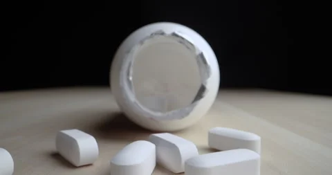 Spilled pill bottle outside in macro dolly shot Stock Footage 283932586