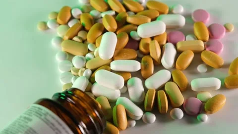 Spilled pills, It is seen that colored pills are scattering from medicine box Stock Footage 167286213