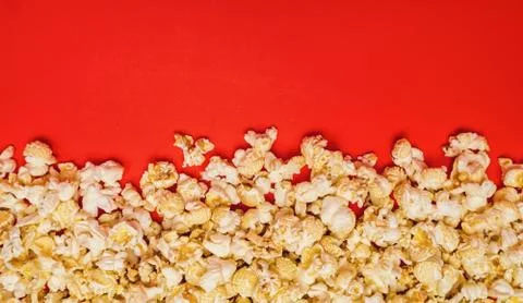 Spilled popcorn on a red background Foto stock