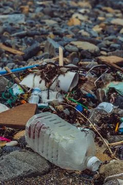 Spilled vivid multi colour garbage on stones background. Closeup big plastic Foto stock