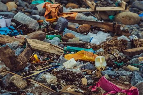 Spilled vivid multi colour garbage on stones background. Environmental total Stock Photos