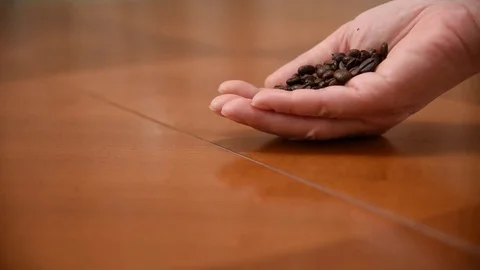Spilling coffee beans on the table Stock Footage 75047236