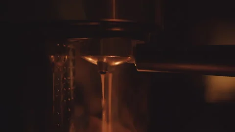 Spilling coffee in a small coffee machine. Steam from the drink. Stock Footage 259551221