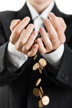 Spilling coins in hands Stock Photos