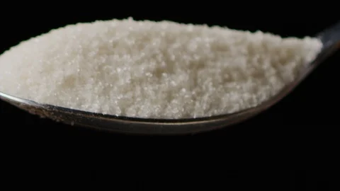 Spilling sugar from spoon macro shot Stock-Footage 128493248