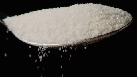 Spilling sugar from spoon macro shot Stock Footage 128493323