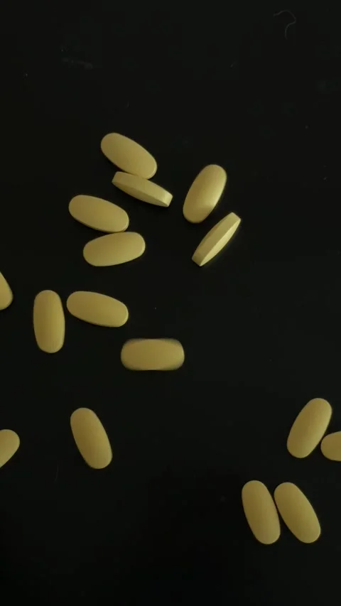 Spilling Yellow Medication Pills Top View 動画素材 340340985