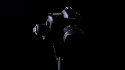 Spin and tilt-down movements of a Nikon D750 DSLR camera using a Zhiyun Crane-2 Stock Footage 108520018