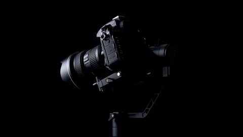 Spin and tilt-down movements of a Nikon D750 DSLR camera using a Zhiyun Crane-2 Stock Footage 108524567