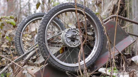 Spin old rusty wheel on overturned wheelbarrow 動画素材 56748426