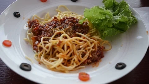 Spin the pasta with tomatoes and forcemeat on the fork. HD, 1920x1080, slow Stock Footage 94252628