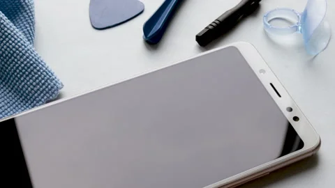 Spin on table many tempered glass screen protectors and mobile phone Stock Footage 194442793