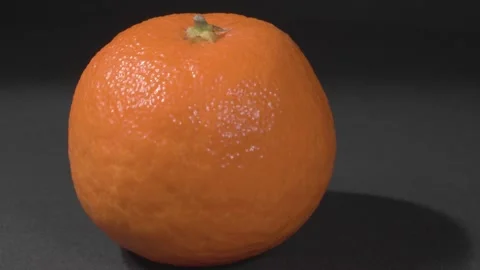 The spin of the tangerine close-up. Black background. Ripe fruit. Видео 143261696