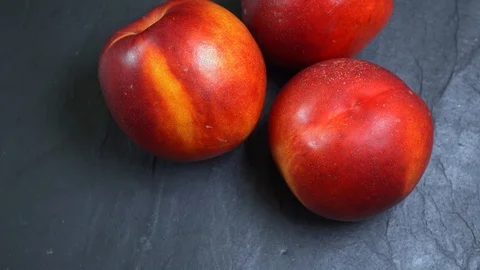 Spin three fresh ripe red and yellow peaches Stock Footage 117289068