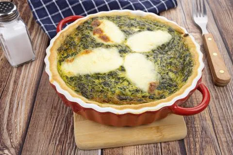 Spinach and mozzarella pie on a table 스톡 사진