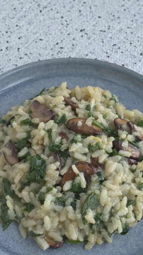 Spinach and mushrooms risotto, copy space, vertical video. Stock Footage 277459904