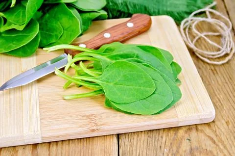 Spinach on the board with a knife Stock Photos