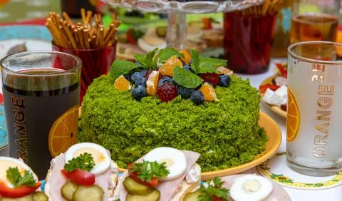 The spinach cake on a festive table Stock Photos