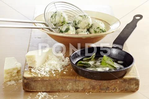 Spinach dumplings with sage butter and Parmesan cheese Stock Photos