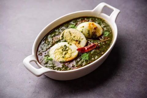 Spinach egg curry is an Indian non vegetarian dish made using palak gravy w.. Stock Photos