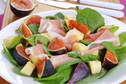 Spinach, figs, sliced ham, mozzarella salad Stock Photos