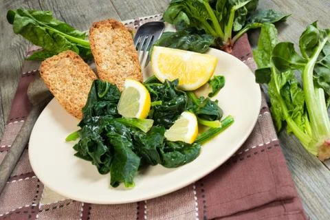 Spinach with lemon Stock Photos