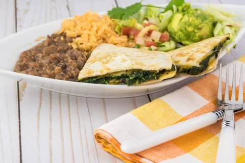 Spinach mushroom quesadillas with refried beans and rice. Stock Photos