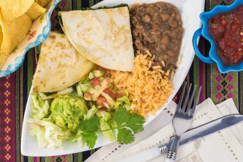 Spinach mushroom quesadillas with refried beans and rice. Stock Photos