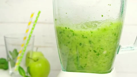 Spinach or apple, fruity green smoothie blended in a blender, healthy eating Stock Footage 154631579