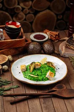 Spinach risotto with fried chicken and broccoli Stock Photos