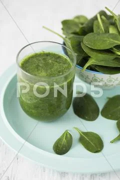A Spinach Smoothie In A Glass With Fresh Spinach