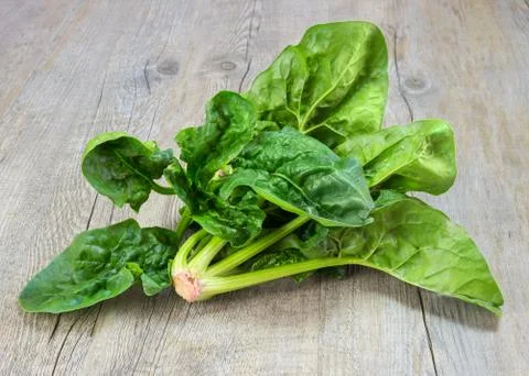 Spinach on wood Stock-Fotos