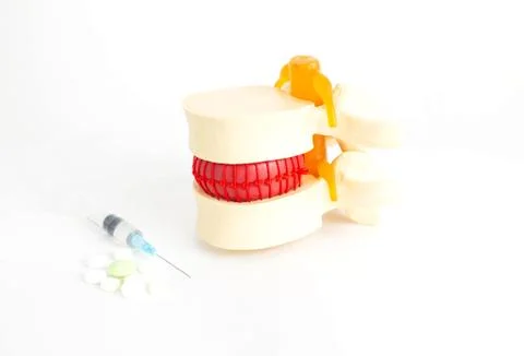 The spine is next to which are the tablets and syringe. The concept of treatment Photos