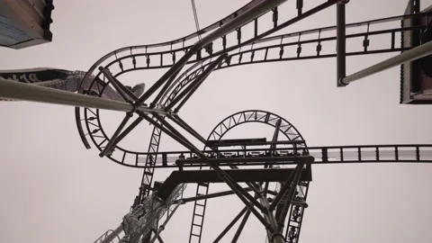 Spining Shot Under Huge Roller Coaster In Amusement park Stock Footage 165343226