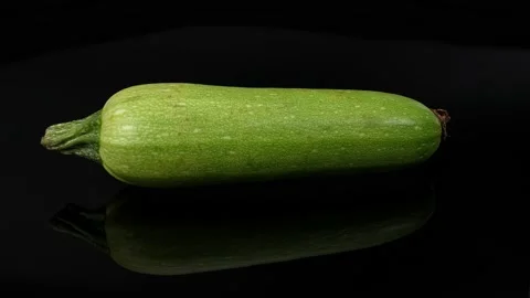 Spining vegetable marrow on the black background Stock Footage 220199676