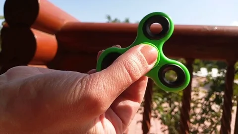Spinner in the hand turns Stock Footage 79766444