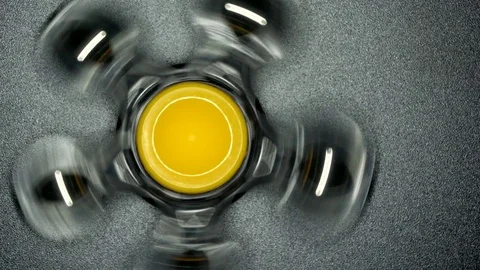 The spinner spinning and move slowly on a black background. Video stock 81045234